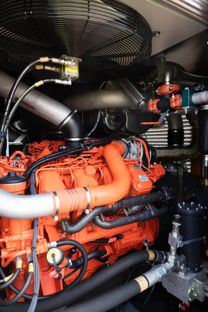 Engine, hoses and cooling components inside a support unit.