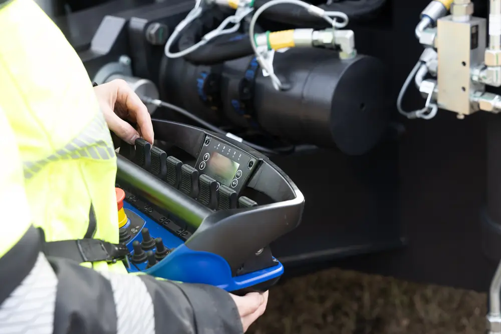 Side detail of the handheld controls and operator.