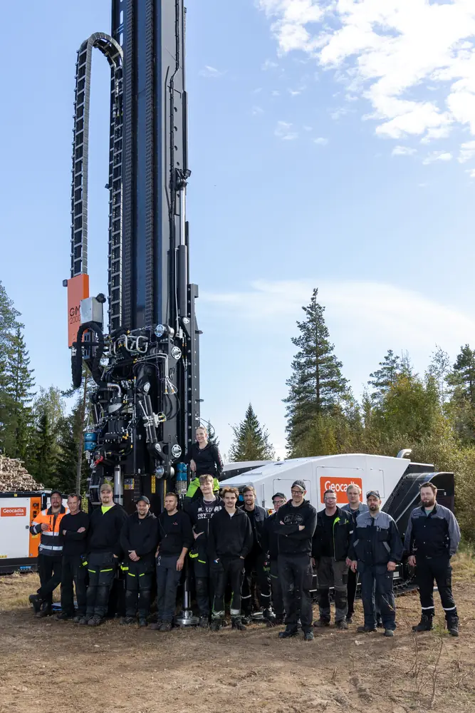 A group standing beside the GM2000 with its mast raised.