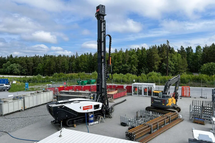 Wide view of Geocadia's Jordbro drilling site, with the branded rig, drill pipes and support equipment