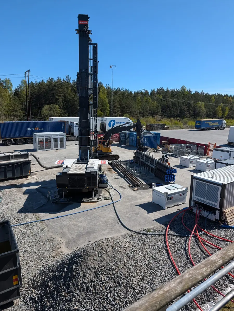Elevated view of the Geocadia drilling rig, stored drill pipes and support equipment at Jordbro, Sweden